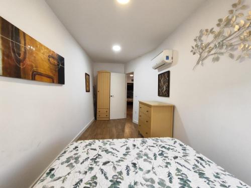 a bedroom with a bed and a painting on the wall at Solaz del Ambroz Hervas 1 in Hervás