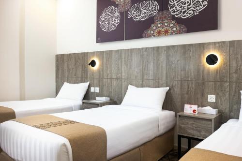 Katil atau katil-katil dalam bilik di Alayam Elite Hotel
