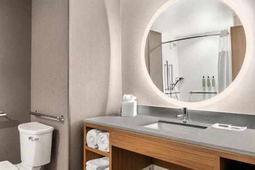 a bathroom with a sink and a mirror at Courtyard by Marriott Milwaukee Brookfield at Poplar Creek in Brookfield