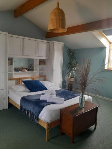 une chambre avec un grand lit et une table dans l'établissement Maison spacieuse proche Nantes 7 personnes, à Sainte-Luce-sur-Loire