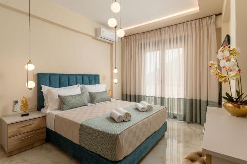 a bedroom with a large bed with two towels at Brikis Villas - With 3 Private Pools in Balíon