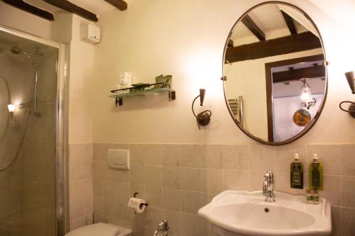 a bathroom with a sink and a mirror at Castello Di Tornano Wine Relais in Gaiole in Chianti