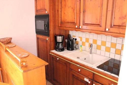 a kitchen with a sink and a microwave at Appartments in Tignes Ecrin des Neiges in Tignes