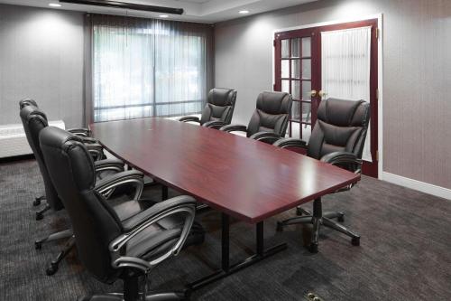 a conference room with a large wooden table and chairs at SpringHill Suites Centreville Chantilly in Centreville