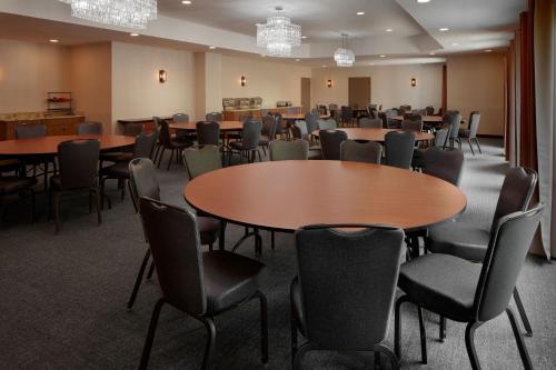 a conference room with tables and chairs and chandeliers at SpringHill Suites Centreville Chantilly in Centreville