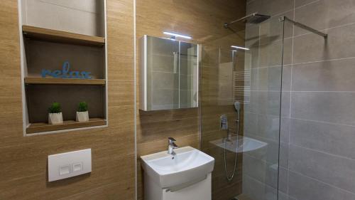 a bathroom with a toilet and a sink and a shower at Aparthotel Phoenix in Bjelašnica