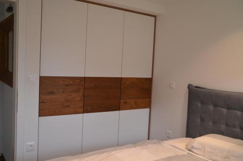 a bedroom with a large white cabinet next to a bed at Delux apartment at Robida Estate in Dolenjske Toplice