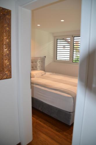 a small bedroom with a bed with a window at Delux apartment at Robida Estate in Dolenjske Toplice