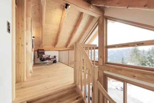 a room with wooden walls and a large window at Chalet Tannenhaus I in Maltaberg
