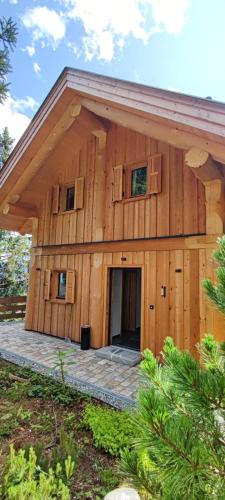 a large wooden building with a large doorway at Chalet Tannenhaus I in Maltaberg