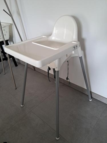 a white chair sitting on a table in a room at Stable Cottage at Le Prieuré in Mantilly