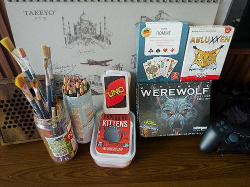 a table with some pens pencils and some books at Nalani Homestay & Hostel Hoi An in Hoi An