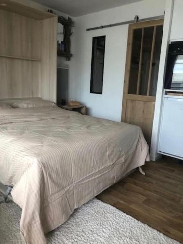une chambre avec un grand lit et une fenêtre dans l'établissement Petit cocon à 50 m de la plage, à Le Touquet-Paris-Plage