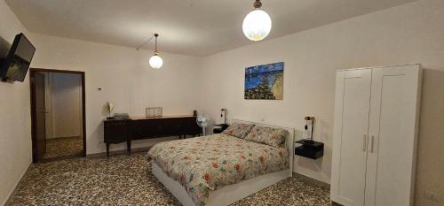 a bedroom with a bed and a desk in it at Letto del Monte guest house in Lettomanoppello