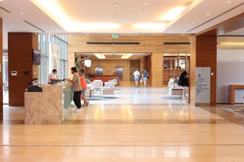 a lobby of a building with people standing at a counter at Hilton Garden Inn Konya in Konya