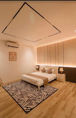 a bedroom with a large bed and a rug at Gaki Hotel in Hue