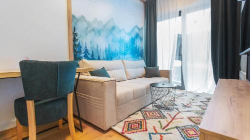 a living room with a couch and a table at Aparthotel Phoenix in Bjelašnica