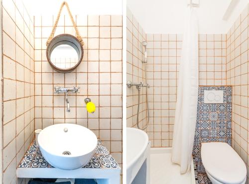 une salle de bain avec un lavabo, des toilettes et un miroir dans l'établissement UniqueAppart - Gare Saint Charles, à Marseille