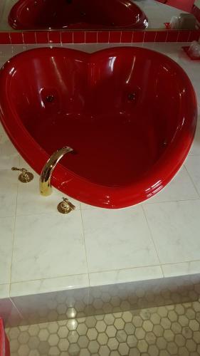 a red sink in a bathroom with at New Relax Inn Bridgeview in Bridgeview