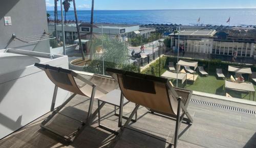 a balcony with chairs and a view of the ocean at Medplaya Hotel Pez Espada in Torremolinos