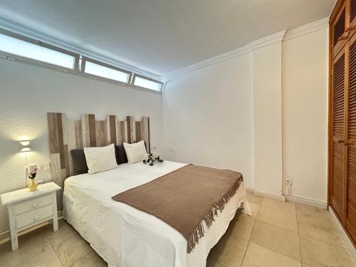a bedroom with a large white bed and a window at Tabaiba views in Tabaiba