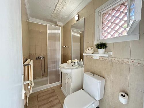 a bathroom with a toilet and a sink and a shower at Tabaiba views in Tabaiba