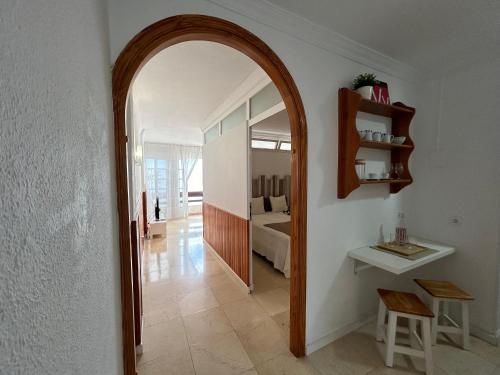a hallway with a mirror and a bed in a room at Tabaiba views in Tabaiba