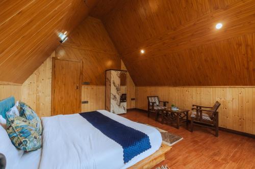 a bedroom with a bed and a wooden ceiling at The Riverwalk in Gushaini