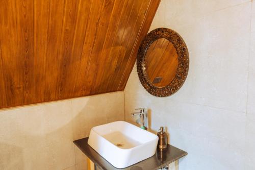 a bathroom with a white sink and a mirror at The Riverwalk in Gushaini