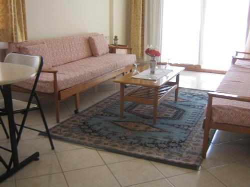 a living room with a couch and a table at Arya Otel in Marmaris