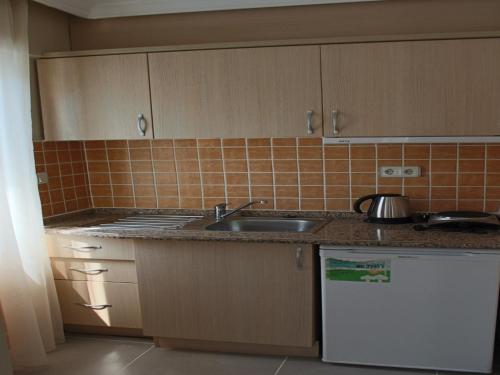 a kitchen with a sink and a counter top at Arya Otel in Marmaris