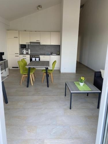 a living room with a table and chairs and a kitchen at Appartement 17 in Oerlinghausen