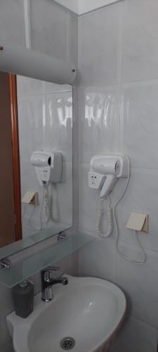 a bathroom with a sink and a mirror at Seaside Studios in Paralia Dionysiou