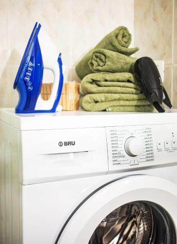 a washing machine with towels on top of it at Casa Tranquila in Puerto de la Cruz