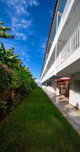 a view of the side of a building with a green lawn at Casa Tranquila in Puerto de la Cruz
