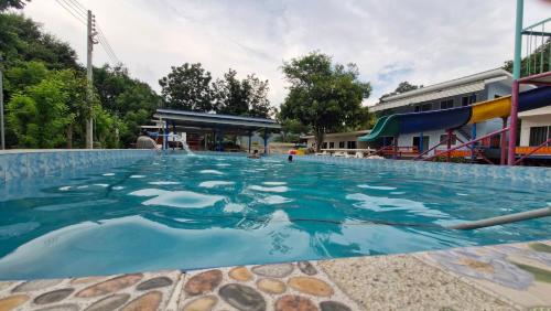 a large swimming pool with a water slide at Eagle View Kaeng Krachan in Kaeng Krachan