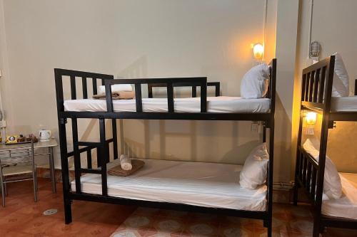 a group of bunk beds in a room at Phuket Old Town Hostel in Phuket Town