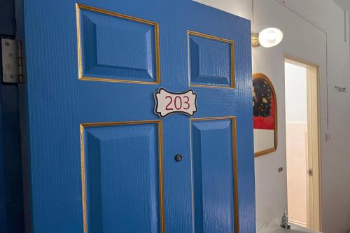 a blue door with a number on it at Phuket Old Town Hostel in Phuket Town