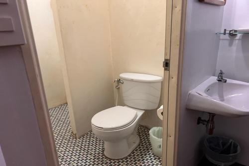 a small bathroom with a toilet and a sink at Phuket Old Town Hostel in Phuket Town