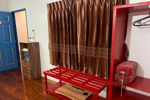 a red bench in a room with a curtain at Phuket Old Town Hostel in Phuket Town