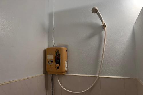 a soap dispenser on a wall in a bathroom at Phuket Old Town Hostel in Phuket Town
