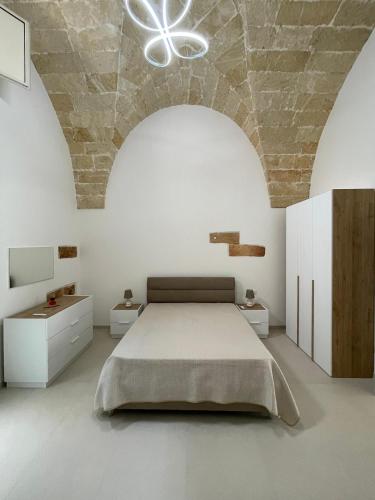 a bedroom with a large bed and a stone ceiling at Casina Carducci Apartment in Nardò