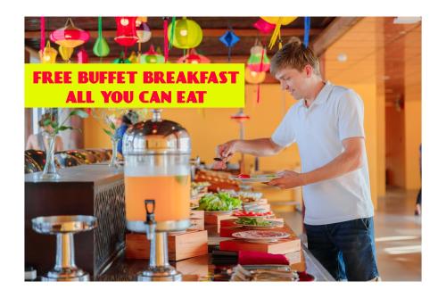 Un uomo che prepara un piatto di cibo a buffet di iHome Hoi An a Hoi An