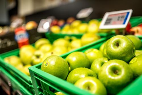 a bunch of green apples in green baskets in a store at Alpine Chalet Sauter in San Vigilio Di Marebbe