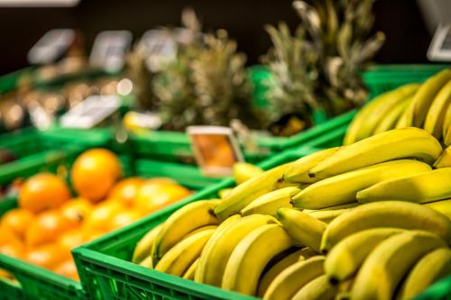 a bunch of bananas and oranges in green baskets at Alpine Chalet Sauter in San Vigilio Di Marebbe