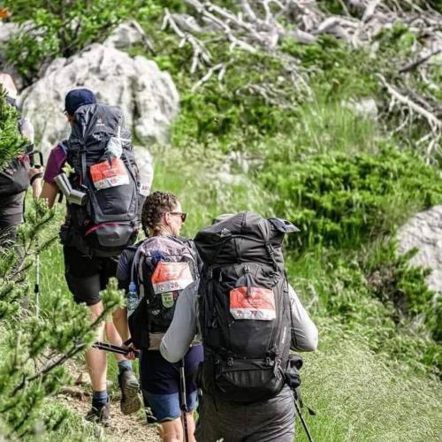 a group of people walking on a trail with backpacks at Jozin put -planinska kuća in Blidinje