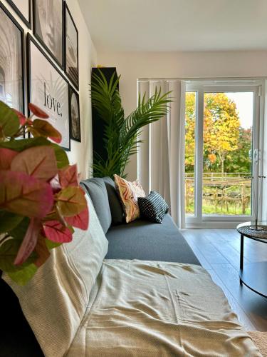 a living room with a couch in front of a window at Newbuild Riverview 3BDR House near Glasgow in Dalmuir