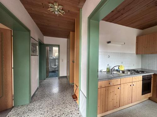 a kitchen with green and white walls and a sink at Chalet Josi in Leutasch