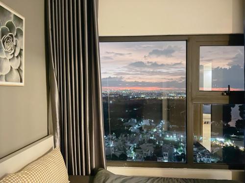 a room with a window with a view of a city at 2BR 69m2 Beautiful view at Vinhomes Grand Park in Gò Công