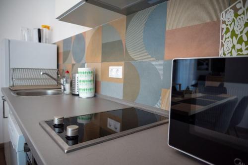 a kitchen with a sink and a counter top at Pipi és Papi vendégház in Kiskunlacháza